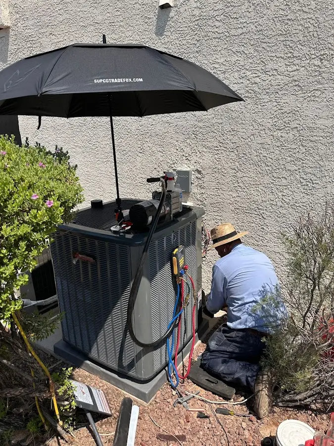 HVAC technician performing outdoor AC maintenance in Lake Los Angeles